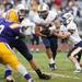 Saline senior quarterback Tyler Palka hands the ball off to junior running back Brad McCormick on Friday. The Saline Hornets defeated Ypsilanti 49-14. Daniel Brenner I AnnArbor.com